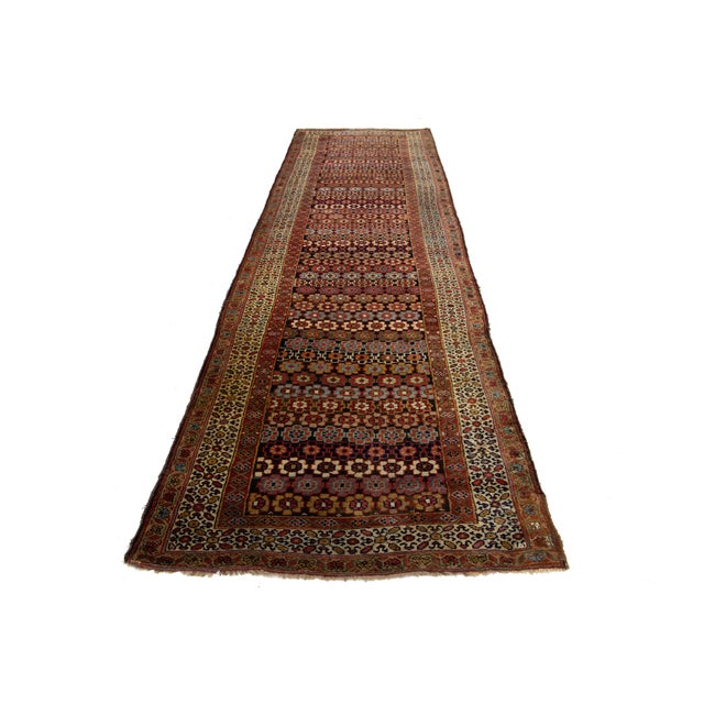 This beautiful 20th-century Malayer hand-knotted wool rug has a brown color field. It features stunning multicolor accents...