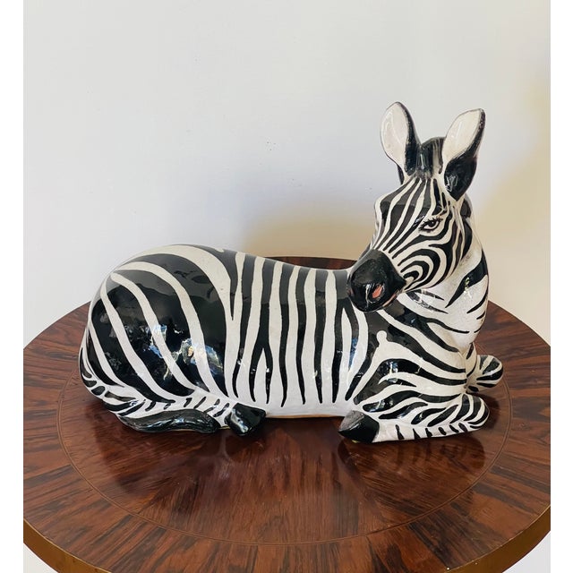 Vintage Italian glazed terracotta recumbent zebra sculpture. Bears stamp made in Italy.