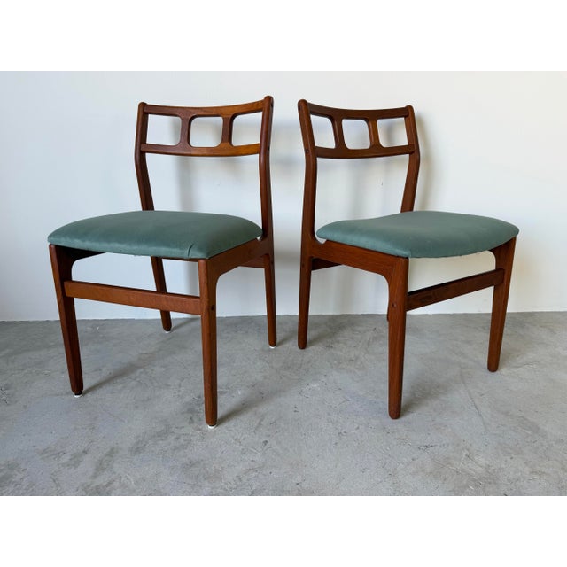A beautiful pair of 1970s Danish Modern dining chairs by D-Scan, crafted in richly grained teak with the clean lines and...