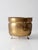 Antique Victorian brass jardiniere featuring a hammered brass body, ring handles, and decorative claw feet. The rounded...