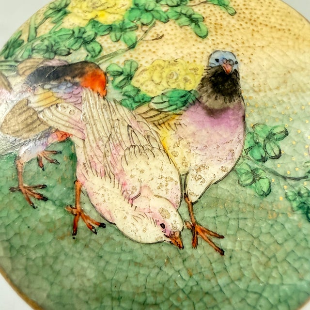 A Satsuma button showing a group of three pigeons in a rural landscape, dating to the late Japanese Edo period, circa...