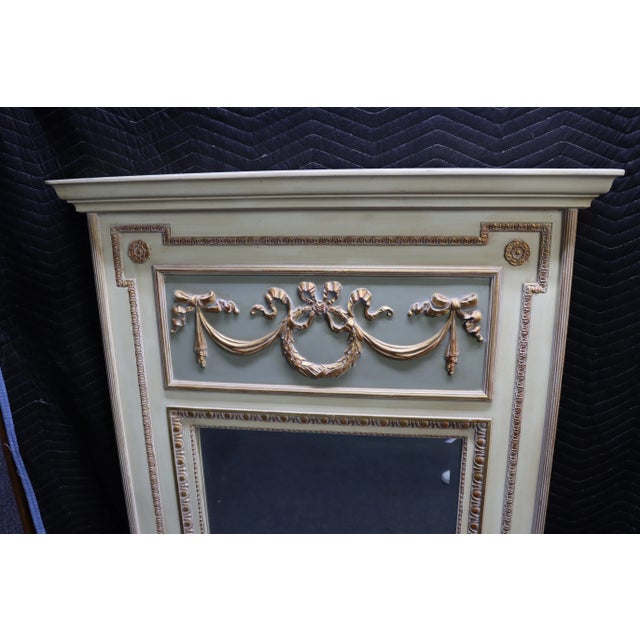 Louis XVI style trumeau mirror with applied gilt wood carved swags and wreath.