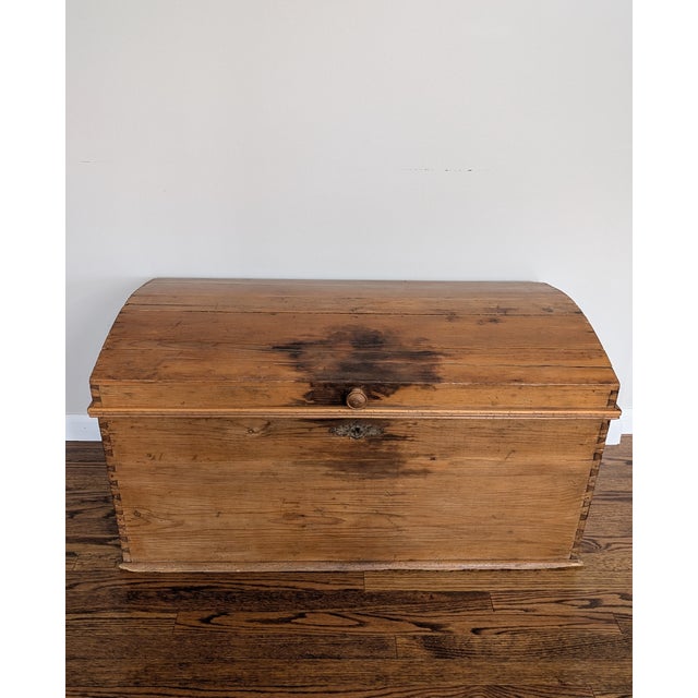 This oversized domed-top pine blanket chest features handcut dovetails, original iron escutcheon, handles, and hinges, and...