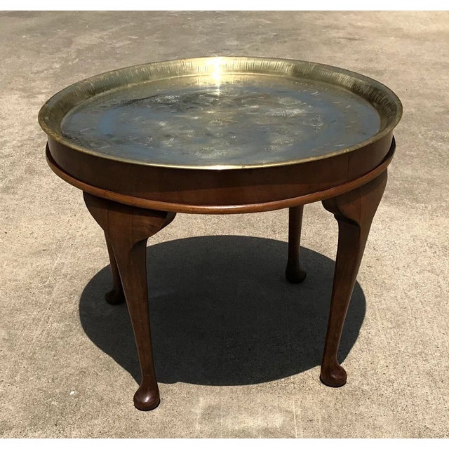 Love this Mid Century brass tray table with wooden base and cabriole legs. Tray has an etched design. Nice! Tray lifts off...