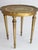 A round mid century Florentine style golden with white side table. The Florentine table is made out of wood and has a nice...