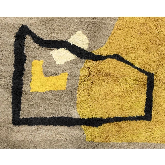 This striking hand-knotted wool rug is a bold contemporary statement piece designed for refined interiors. Measuring 3.73...