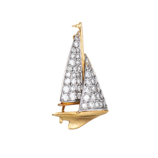 Finely detailed vintage McTeigue Sailboat pendant crafted in 900 platinum and 18k yellow gold (circa 1920s). Diamonds are...