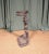A heavy cast iron stick stand to a design by Coalbrookdale, in the form of a dog holding a hunting whip in its jaws, on a...