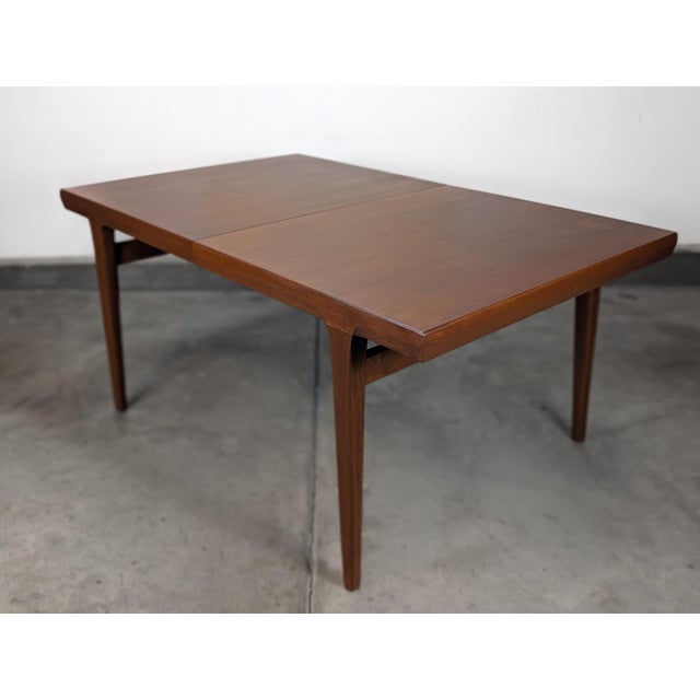 A striking example of Scandinavian modern design, this vintage 1960s expandable teak dining table — crafted in the manner...