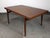 A striking example of Scandinavian modern design, this vintage 1960s expandable teak dining table — crafted in the manner...