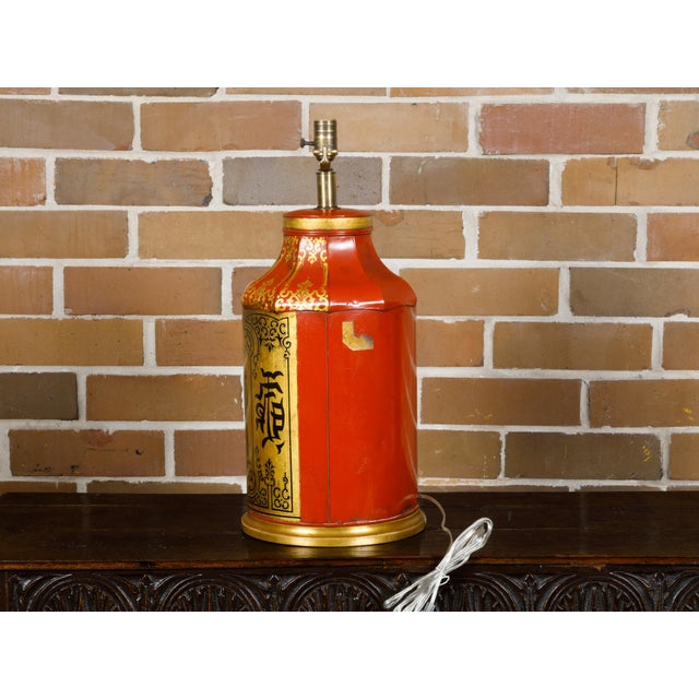 An English Chinoiserie tea tin red and gold canister from the 19th century made into a table lamp wired for the USA. This...