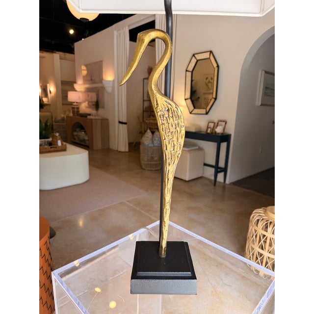 This contemporary coastal-inspired table lamp makes a striking statement with its sculptural heron motif and elegant...