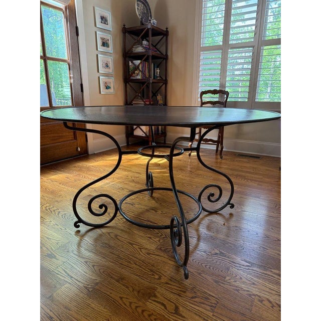 Great hammered tin table in a rubbed bronze finish with a scrolled iron base. Perfect for a breakfast room or as an accent...