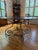 Great hammered tin table in a rubbed bronze finish with a scrolled iron base. Perfect for a breakfast room or as an accent...