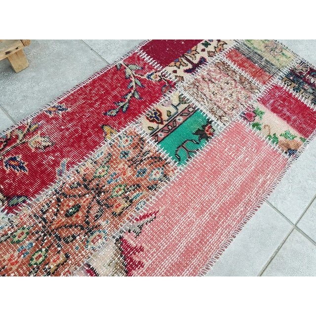 This is a vintage Turkish Oushak rug from the Mid 20th Century. The piece was hand-knotted.
