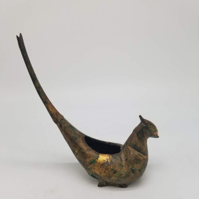 This is an antique iron incense burner crafted in the shape of a stylized bird with an elongated tail. The piece features...