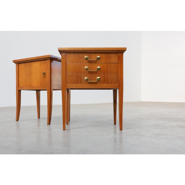 An elegant and uncommon pair of French mid-century bedside tables dating from the 1950s, distinguished by their...