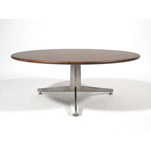 Ward Bennett's expert use of line and proportion are evident in this beautiful coffee table with a three legged aluminum...