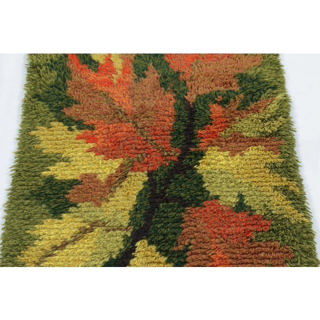 Hand-knotted in lush, high-pile wool in Sweden circa 1960-1970, this 2x4 vintage Swedish Rya runner rug is a bold new...