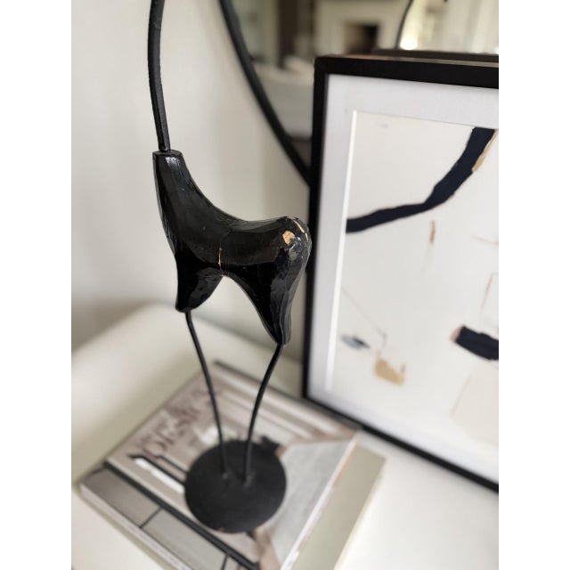 This Mid 20th century piece was influenced from the Art Deco and Mid-century Era's. The black metal finish and the...