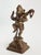 Vintage Indian brass figurine depicting Ganesha in a dynamic dancing pose, raised on a stepped lotus-form base with his...