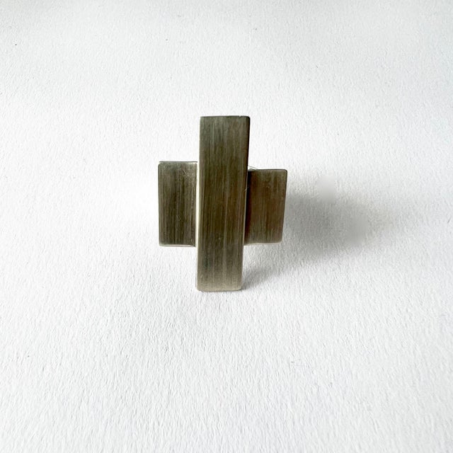 Early, brushed sterling silver ring created by Betty Cooke of Baltimore, Maryland. Completely handmade, the crossbar is...