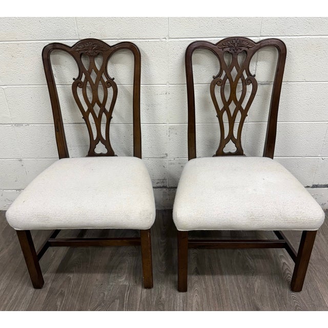 This is a gorgeous pair of vintage Chippendale style mahogany dining chairs with Georgian influence. Features elegant...