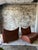 A sculptural and incredibly comfortable pair of vintage leather sling lounge chairs in a rich cognac saddle-tone leather....