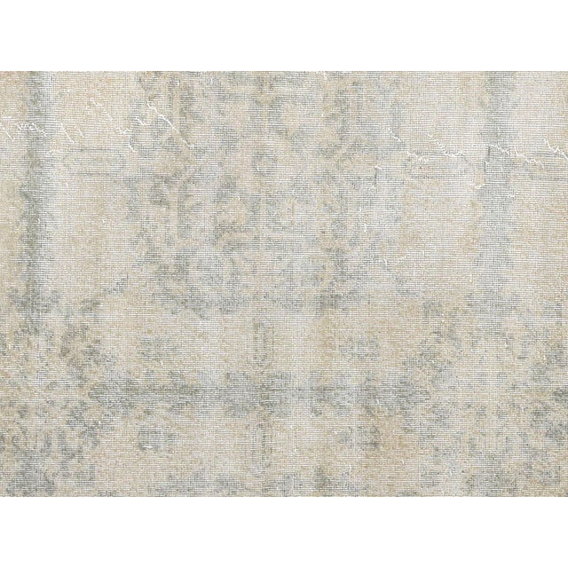 This vintage Turkish Oushak rug, handwoven with wool on a wool foundation, measures 7'10" by 11'4" and originates from the...