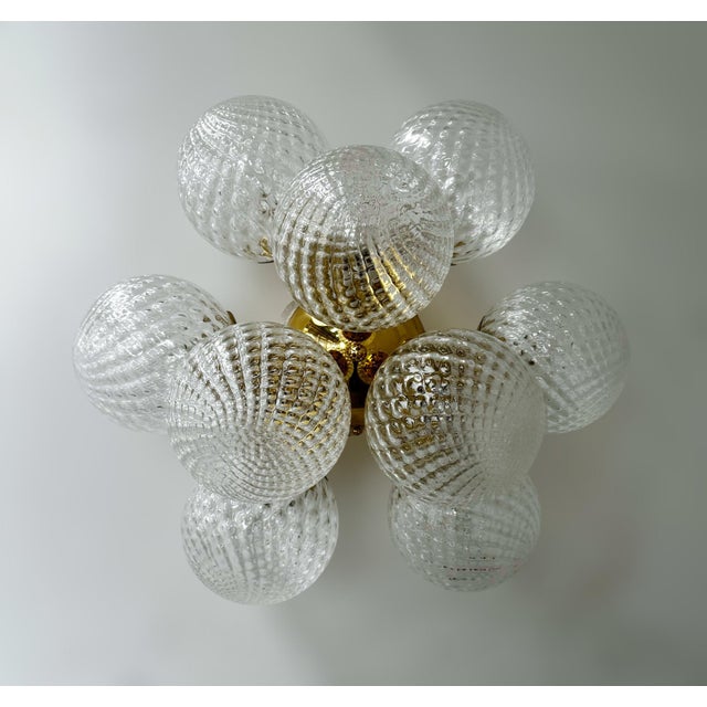 Italian flush mount with nine clear textured balloton Murano glass globes mounted on solid brass frame in lacquered...