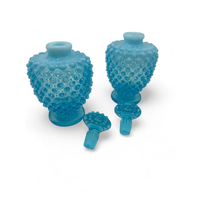 Add a touch of vintage charm to your vanity or dresser with this exquisite set of two 1940's Fenton Blue Opalescent...