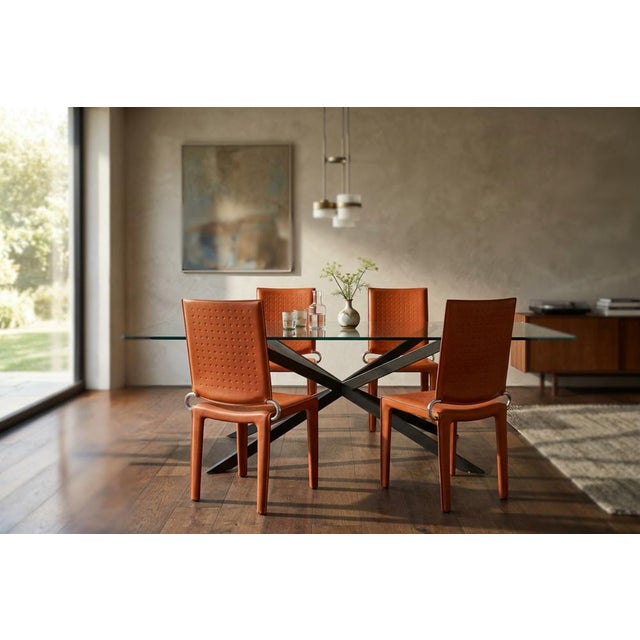 A stunning set of 4 designer chairs, featuring elegant lines and high-quality materials. The chairs feature a sturdy iron...