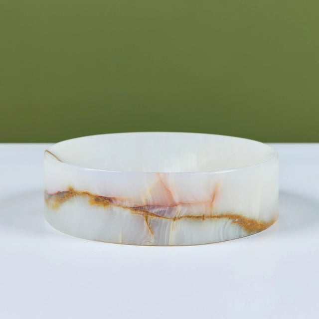 Polished onyx ashtray features an all over cream color with brown and red veining throughout and a thick edge. The round...