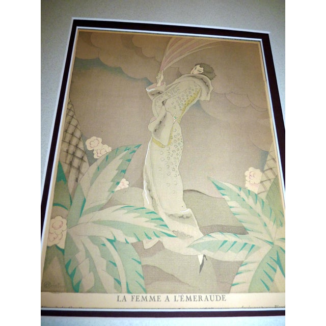 This stunning original Art Deco fashion pochoir, titled "La Femme à l'Émeraude" (The Woman with the Emerald), was...