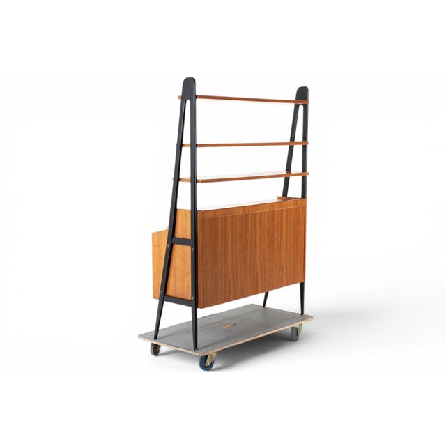This 1960s teak bookcase brings a bold graphic touch to classic Scandinavian storage, with tall side gables ebonized in...