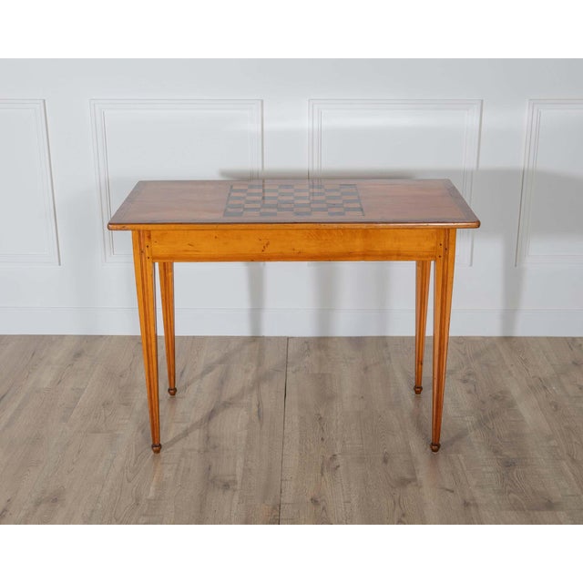 A beautiful late Gustavian game table, circa 1840, crafted in cherry with nutwood inlays, combining refined neoclassical...