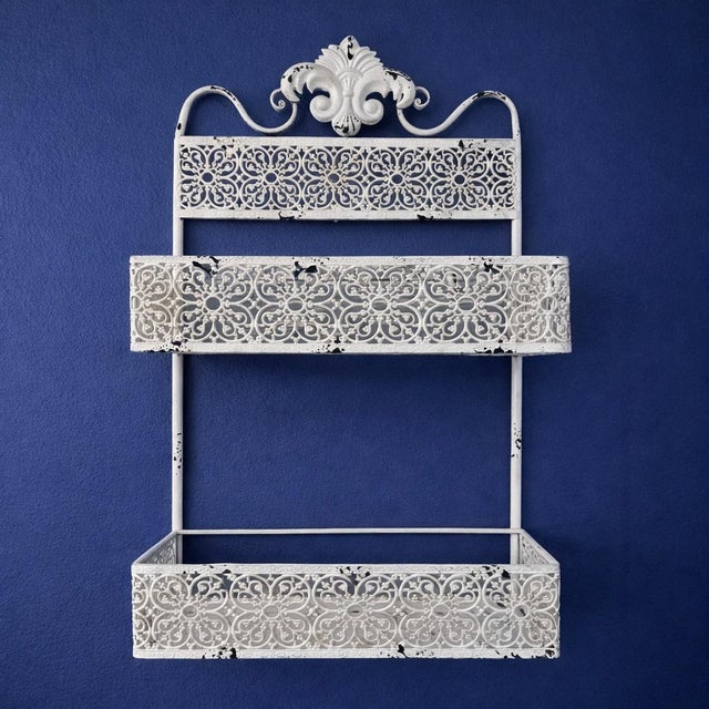 Vintage Distressed Metal Vanity Wall Shelf An elegant vintage metal vanity shelf featuring intricate scrollwork and floral...