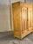 A handsome 19th-century Dutch pine wardrobe with beautifully simple paneled doors, dovetailed construction and turned bun...
