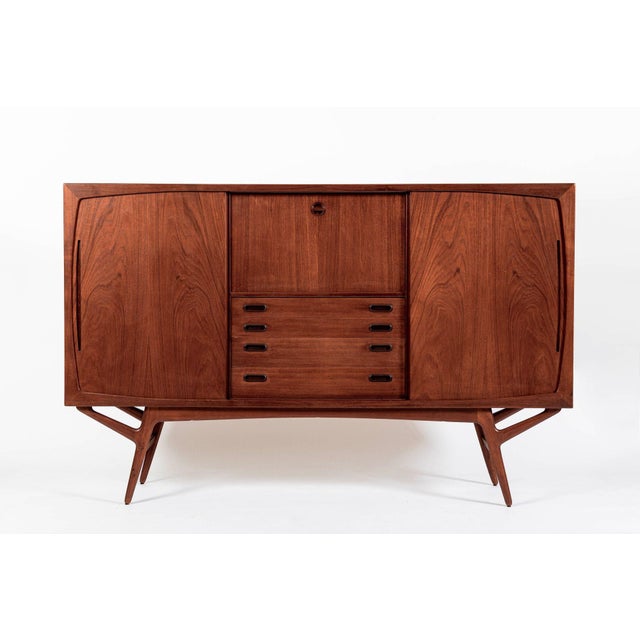 This vintage mid century Danish modern tall teak wood sideboard cabinet or bar cabinet attributed to Harry Ostergaard for...