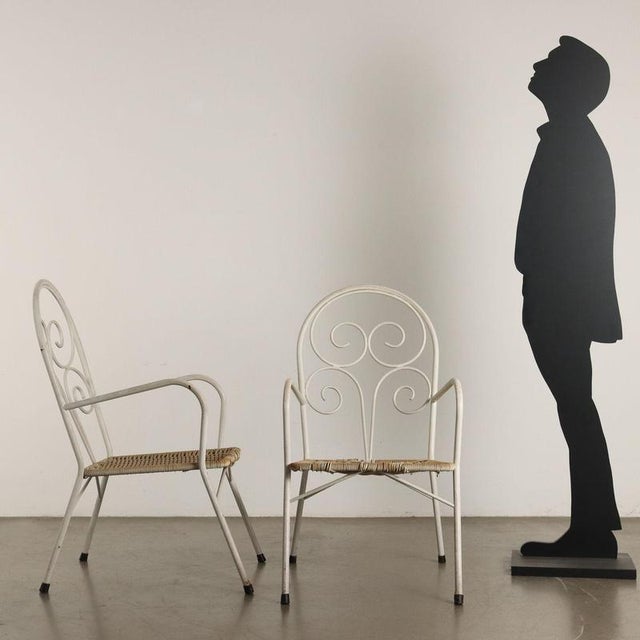 Set of four vintage garden chairs with white enamelled iron frame and plastic rope seat. This piece is attributed to the...