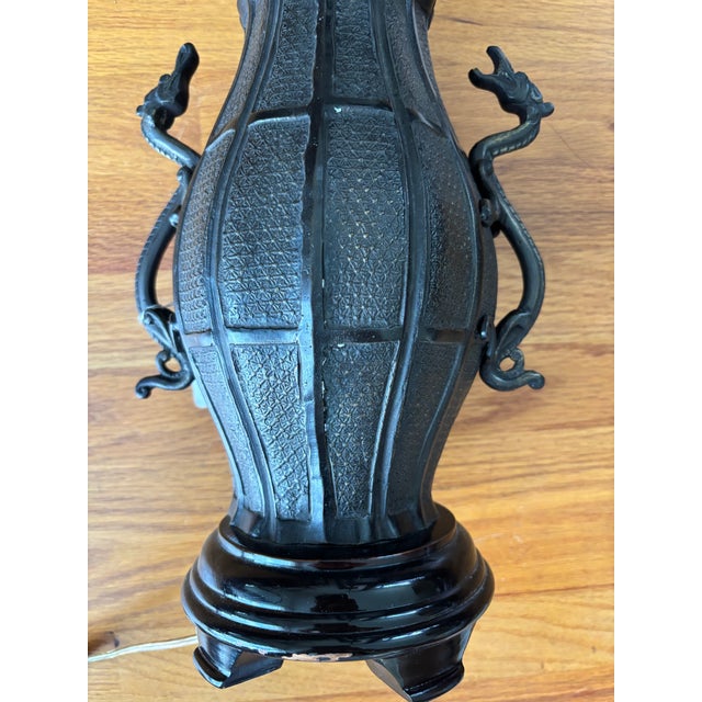 This striking vintage table lamp features an Asian vase-form base crafted from heavy, patinated dark bronze-finished...