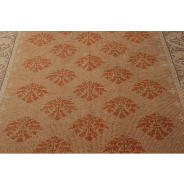 Hand-knotted in wool originating from England circa 1910-1920, this Axminster antique rug enjoys rare gallery size...