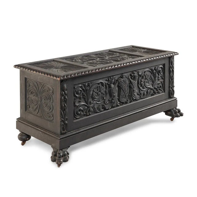 striking late 19th-century Renaissance Revival blanket chest or coffer crafted in richly toned carved oak. The lift-top...