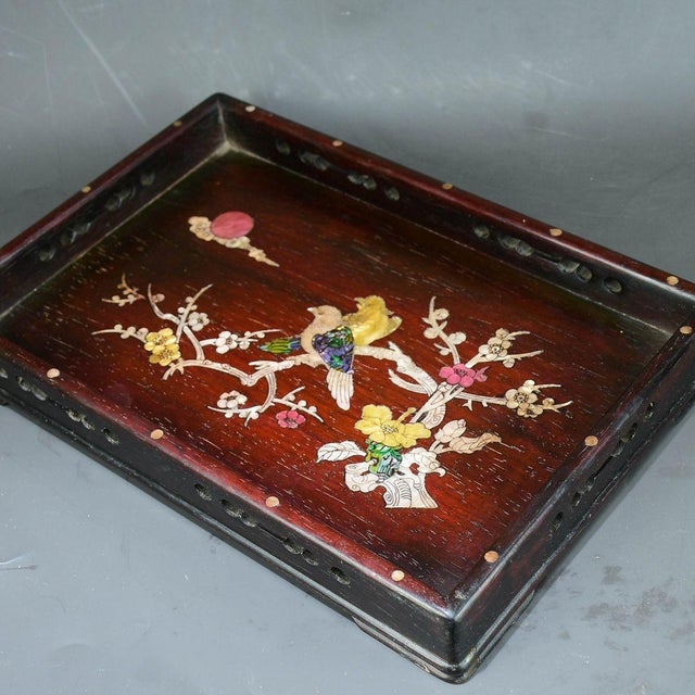 This is a beautifully crafted wooden tray featuring intricate mother-of-pearl (nacre) inlay work. Crafted from a richly...