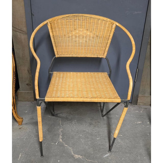 Pair of wrought iron and wicker arm chairs. Mid Century modern , strong sturdy chairs.They can be used indoor or outdoor....