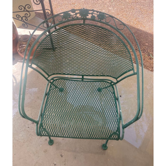 One vintage Metal Garden Chair in green with curved back and floral accents. This individual chair was part of an outdoor...