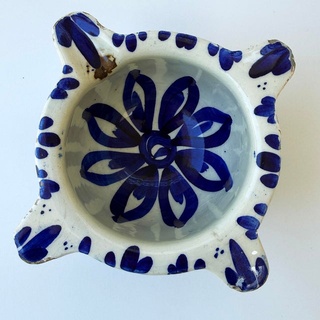 A charming French stoneware mortar decorated in a bold hand-painted blue floral design on a cream ground. Featuring the...