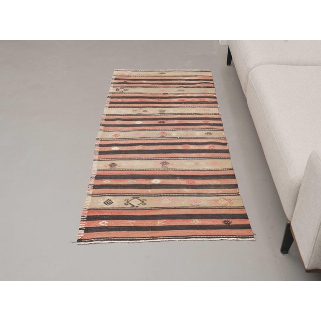 Vintage Hand-Knotted runner rug is a semi-antique vintage area rug. The '70s Eastern region of Anatolia's unique rug is...