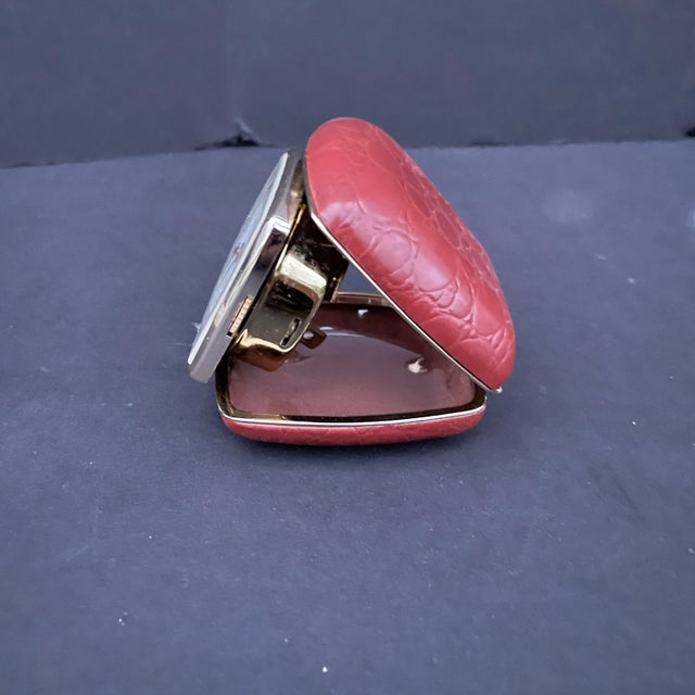 Discover the timeless elegance of the Linden Travel Alarm Clock, encased in a luxurious burgundy leather case. This...