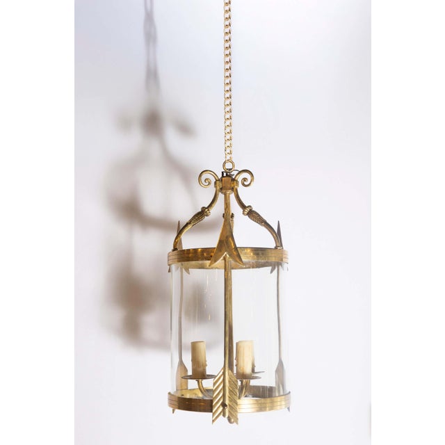 A striking pair of French neoclassical brass lantern chandeliers from the 1940s, exuding elegance and sophistication with...